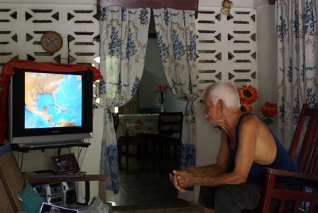 Watching a weather report in Havana.