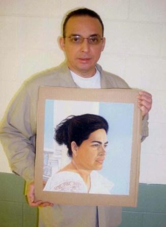 Antonio Guerrero with painting of Adriana Perez wife of Gerardo Hernandez, Florence Federal Prison. The painting belongs to the traveling entitled Bridge of Solidarity