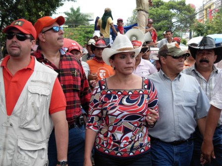 The president’s wife, Xiomara Castro de Zelaya, center, came out of hiding to head Tuesday’s march.