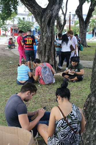 Using the pay-for Wi-Fi in Monaco Park, Havana. Photo: Juan Suarez