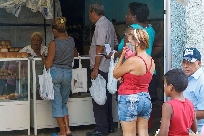 Havana residents in line for their rationed bread rolls.