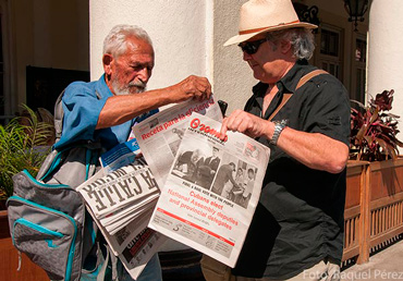 The elderly begin to stand in line in the early morning to buy newspapers they later resell for a few extra cents. 