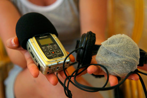 Digital recorder, headphones and a microphone.