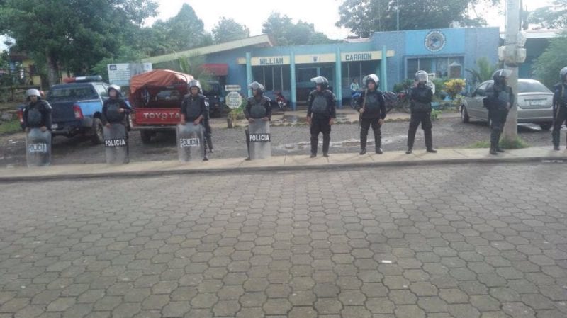 Riot police surrounding the police station in New Guinea. 