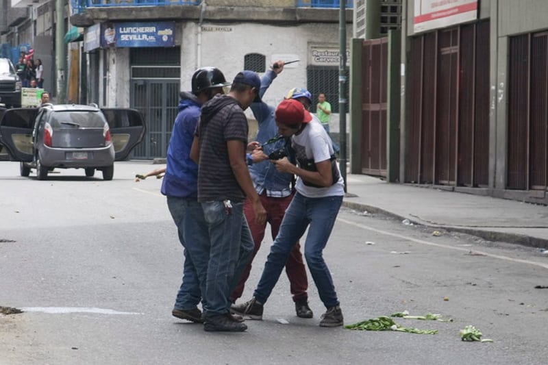 Journalists being attacked in downtown Caracas.
