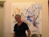 Pilar Bustos, Ecuadorian  painter alongside one of her works.