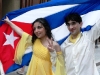 Two passersby with the Cuban flag.