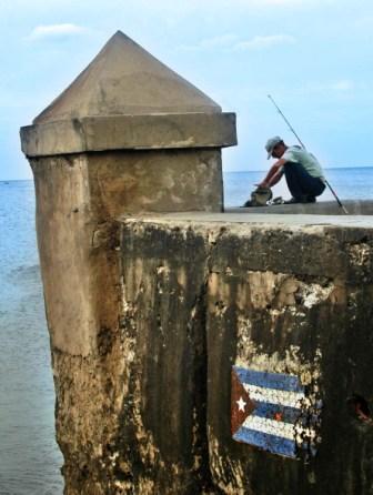 Fishing on the Havana Malecon seawall, photo by Caridad
