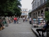 Obispo St. with booksellers.  At the end of the street is the Santa Isabel Hotel.