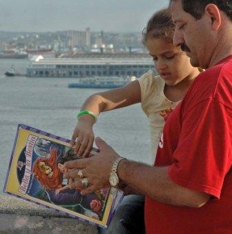 Reading over Havana Bay, photo by Caridad