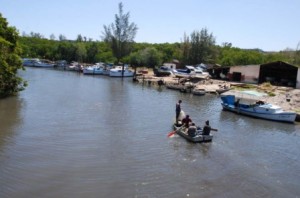 The Cojimar River, still calm, hopes its romantic little boat will return some day.