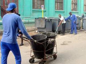 Overall-clad police officers cleaning the streets of Centro Habana on December 31. Photo: Tribuna de la Habana.
