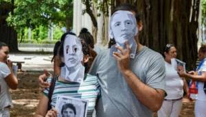 Activists brought masks of Obama to a Sunday march