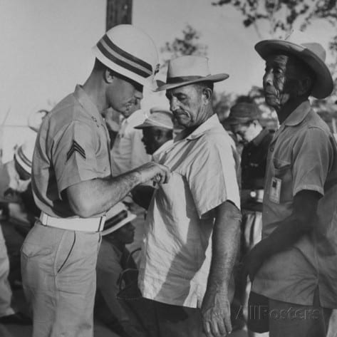 Cuban civilian workers being searched as they leave GITMO after work.