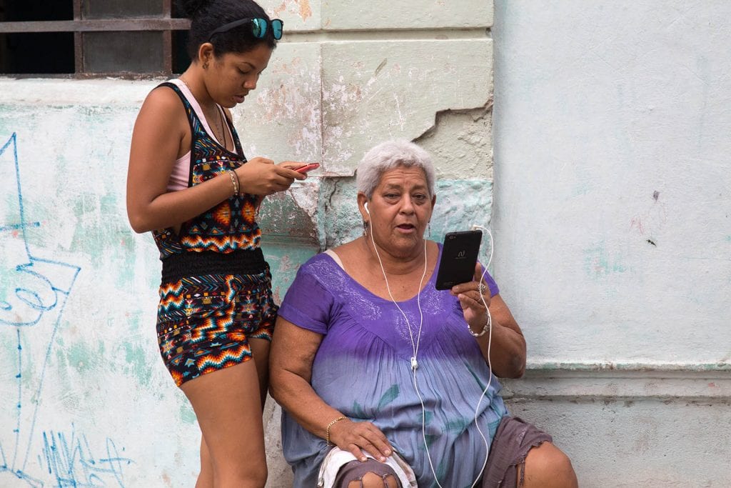 Different generations using the pay-for Wi-Fi in Havana.