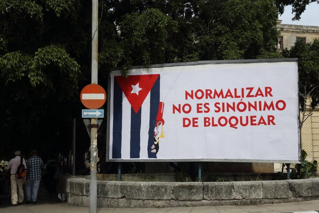 The Cuban government was highly critical of Obama's moves towards normalization considering them not enough. The sign reads: Normalization is not synonimous for blockading.